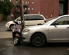 Tumbnail of image three car parked on top of vespa.