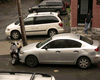 Tumbnail of image one car parked on top of vespa.